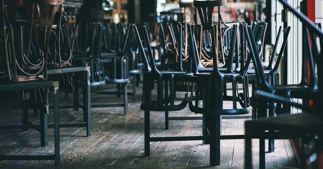 Chairs and tables stacked in a closed pub